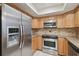 Modern kitchen featuring stainless steel appliances and granite countertops at 251 Hidden Brook Dr # 102C, Palm Harbor, FL 34683