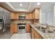 Well-equipped kitchen featuring stainless steel appliances and granite countertops at 251 Hidden Brook Dr # 102C, Palm Harbor, FL 34683