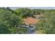 Aerial view of a house nestled in a lush, tree-lined community at 251 Hidden Brook Dr # 102C, Palm Harbor, FL 34683