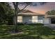 Single-story home with attached garage and lush landscaping at 251 Hidden Brook Dr # 102C, Palm Harbor, FL 34683