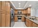 Modern kitchen with stainless steel appliances and wood cabinets at 251 Hidden Brook Dr # 102C, Palm Harbor, FL 34683