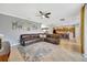 Open-concept Gathering room with a large sectional sofa and kitchen views at 10820 Carloway Hills Drive, Wimauma, FL 33598