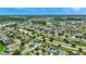 Aerial view of a large community with houses, streets, and a lake at 10820 Carloway Hills Drive, Wimauma, FL 33598
