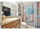 Bathroom with single vanity and floral shower curtain at 10820 Carloway Hills Drive, Wimauma, FL 33598