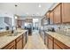 Modern kitchen with granite countertops and stainless steel appliances at 10820 Carloway Hills Drive, Wimauma, FL 33598