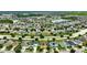 Aerial view of a large community with houses, streets, and a lake at 10820 Carloway Hills Drive, Wimauma, FL 33598