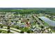 Aerial view of a house in a residential neighborhood near a lake at 10820 Carloway Hills Drive, Wimauma, FL 33598