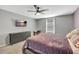 Bedroom with a queen bed, dresser, and wall-mounted TV at 10820 Carloway Hills Drive, Wimauma, FL 33598