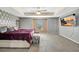 Large main bedroom with a king-size bed and a large TV at 10820 Carloway Hills Drive, Wimauma, FL 33598
