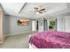 Spacious main bedroom with large TV, carpet flooring, and walk-in closet at 10820 Carloway Hills Drive, Wimauma, FL 33598