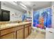 Bathroom with a double vanity and artistic shower curtain at 10820 Carloway Hills Drive, Wimauma, FL 33598
