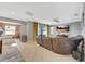 Spacious Gathering room featuring a large sectional sofa and a large TV at 10820 Carloway Hills Drive, Wimauma, FL 33598