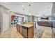 Modern kitchen with an island and views into Gathering room at 10820 Carloway Hills Drive, Wimauma, FL 33598