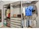 Large walk-in closet with ample shelving and hanging space at 10820 Carloway Hills Drive, Wimauma, FL 33598