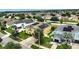 Aerial view of a yellow two-story house with solar panels and a trampoline in the backyard at 10820 Carloway Hills Drive, Wimauma, FL 33598