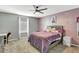 Bedroom with a queen bed, gray walls, and ceiling fan at 10820 Carloway Hills Drive, Wimauma, FL 33598