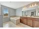 Primary bathroom with soaking tub, double vanity, and large mirror at 10820 Carloway Hills Drive, Wimauma, FL 33598