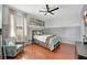 Bedroom with a queen bed, wood floors, and ceiling fan at 10820 Carloway Hills Drive, Wimauma, FL 33598