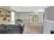 Bonus room with large screen, comfortable seating, and adjacent bathroom at 10820 Carloway Hills Drive, Wimauma, FL 33598