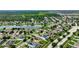 Aerial view of a residential neighborhood with houses, roads, and a lake at 10820 Carloway Hills Drive, Wimauma, FL 33598