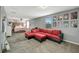Bright bedroom featuring a bed, seating area, and wall art at 10820 Carloway Hills Drive, Wimauma, FL 33598