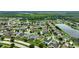 Aerial view of a large community with houses, streets, and a lake at 10820 Carloway Hills Drive, Wimauma, FL 33598
