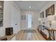 Bright entryway with wood-look floors, a stylish console table, and access to the main living areas at 2860 14Th N Ave, St Petersburg, FL 33713