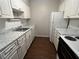 Bright kitchen features white cabinets, tile backsplash, and modern countertops at 4315 Aegean Dr # 126C, Tampa, FL 33611