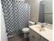 Clean bathroom with a shower/tub combo and patterned shower curtain at 4315 Aegean Dr # 126C, Tampa, FL 33611