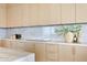 Kitchen with light wood cabinets and marble countertops at 2912 W Santiago St # Ph2402, Tampa, FL 33629