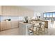 Modern kitchen with light wood cabinets, marble countertops, and island seating at 2912 W Santiago St # Ph2402, Tampa, FL 33629