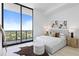 Bright bedroom with a queen-size bed and sliding glass doors leading to a balcony with city views at 2912 W Santiago St # Ph2402, Tampa, FL 33629