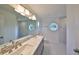 Bathroom boasts double vanity, marble shower and octagon window at 28211 Tanglewood Dr, Wesley Chapel, FL 33543