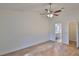 Spacious bedroom with wood-look floors, ceiling fan and en-suite bathroom at 28211 Tanglewood Dr, Wesley Chapel, FL 33543