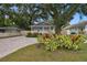 Charming single-story home with a welcoming front porch, well-manicured landscaping, and brick paver driveway at 509 E Paris St, Tampa, FL 33604