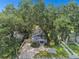 Charming bungalow with a paved driveway, nestled among lush trees at 509 E Paris St, Tampa, FL 33604