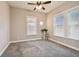 Bright bedroom with gray carpet, ceiling fan and two windows at 509 E Paris St, Tampa, FL 33604