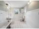 Classic bathroom with white tile, pedestal sink, and clawfoot tub at 455 13Th Ne Ave, St Petersburg, FL 33701