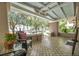 Spacious front porch with patterned tile and wicker seating at 455 13Th Ne Ave, St Petersburg, FL 33701