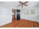 Bright bedroom with hardwood floors, ceiling fan, and access to upper level at 455 13Th Ne Ave, St Petersburg, FL 33701