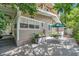 Private backyard with deck, patio furniture, and lush landscaping at 455 13Th Ne Ave, St Petersburg, FL 33701