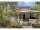 Two-story house with a welcoming porch and lush landscaping at 455 13Th Ne Ave, St Petersburg, FL 33701