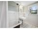 Clean bathroom with white tile, pedestal sink, and clawfoot tub at 455 13Th Ne Ave, St Petersburg, FL 33701