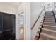 Staircase with wood railing and neutral carpet runner at 455 13Th Ne Ave, St Petersburg, FL 33701