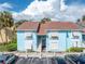 Light blue condo building with white shutters and stairs at 3730 42Nd S Way # G, St Petersburg, FL 33711