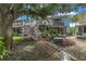 Spacious backyard with mature trees and a stairway leading to a patio at 3730 42Nd S Way # G, St Petersburg, FL 33711