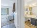 View of bedroom and bathroom with wood-look floors and updated vanities at 3730 42Nd S Way # G, St Petersburg, FL 33711