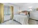 Spacious bedroom with a comfortable bed, dresser, and large window at 3730 42Nd S Way # G, St Petersburg, FL 33711