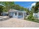 Quaint cottage with light blue exterior, green roof, and a paved driveway at 724 Gulf Blvd # A & B, Indian Rocks Beach, FL 33785
