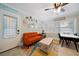 Beach-themed living room with orange couch at 724 Gulf Blvd # A & B, Indian Rocks Beach, FL 33785